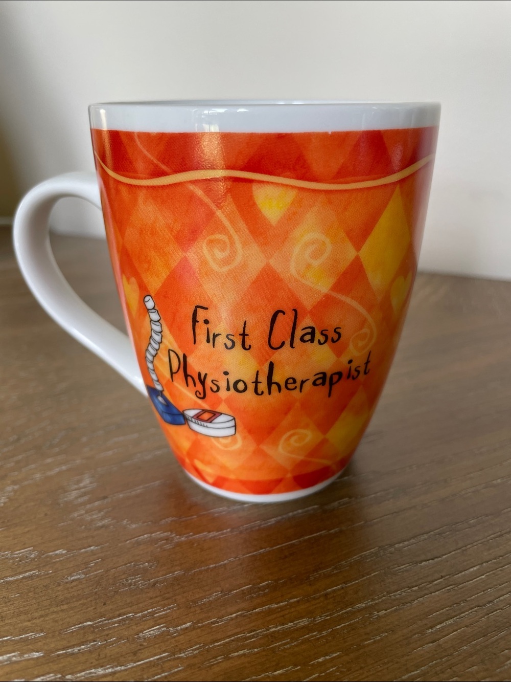 First Class Physiotherapist Orange Ceramic Mug with funny saying